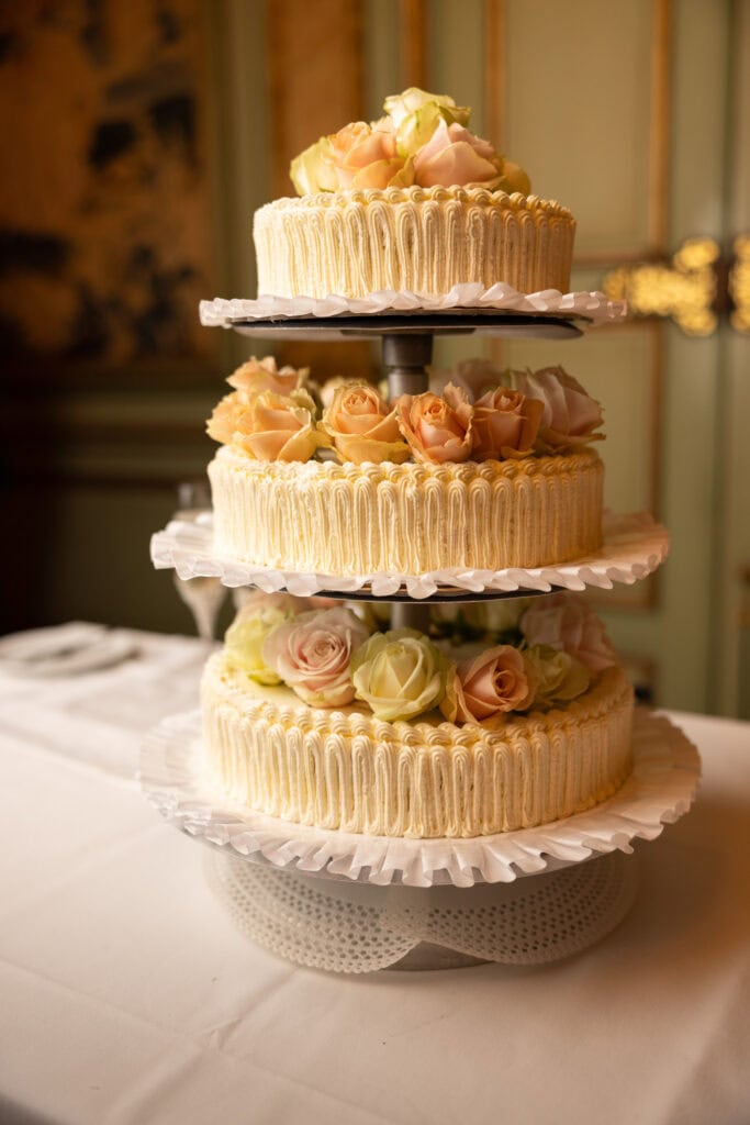 Emotional cake-cutting moment with bride and groom smiling at Villa Wenkenhof wedding in Switzerland.
