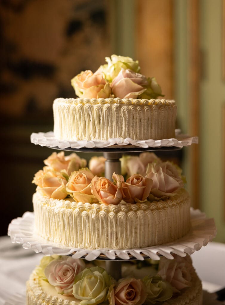 Emotional cake-cutting moment with bride and groom smiling at Villa Wenkenhof wedding in Switzerland.