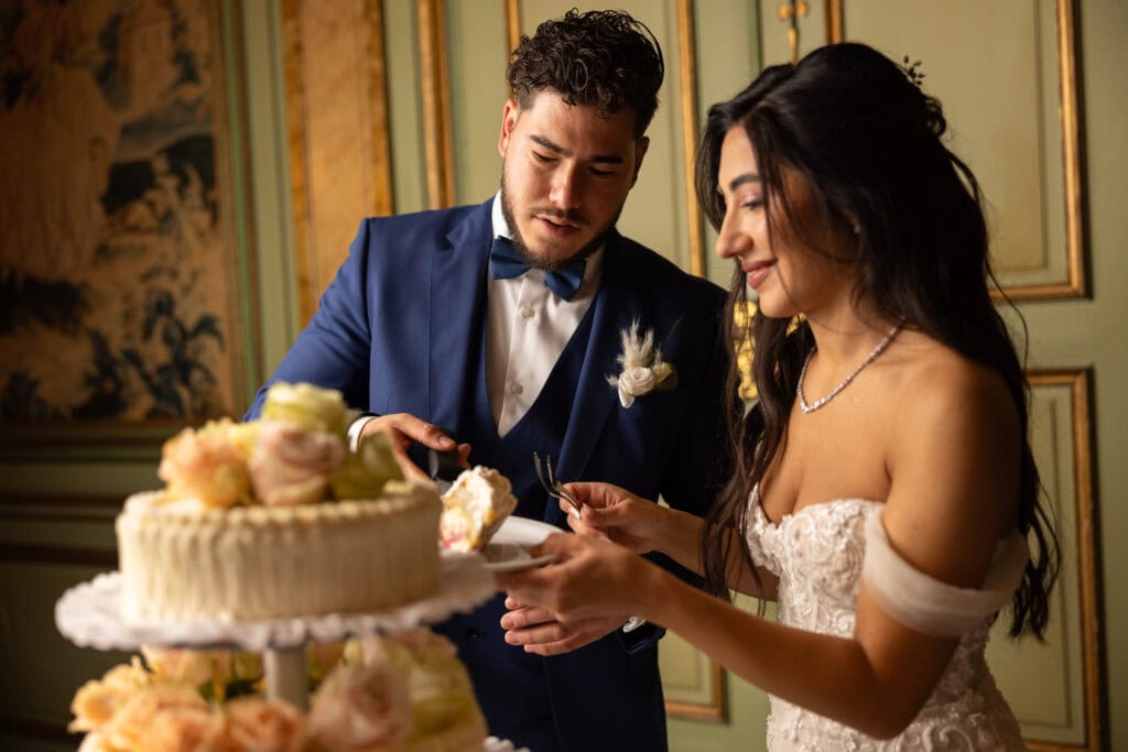 Emotional cake-cutting moment with bride and groom smiling at Villa Wenkenhof wedding in Switzerland.