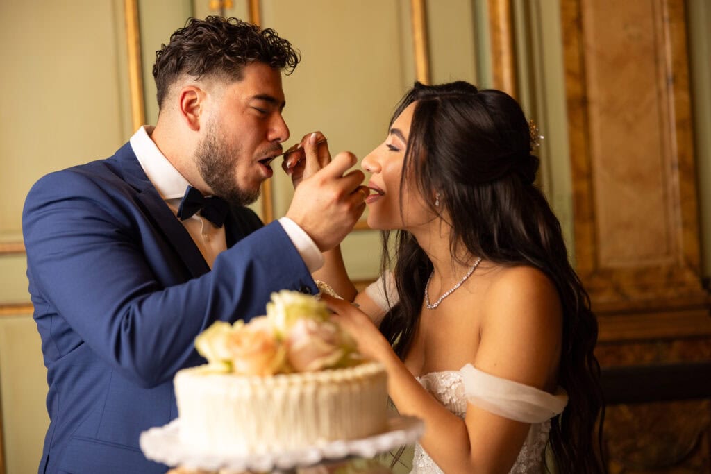 Emotional cake-cutting moment with bride and groom smiling at Villa Wenkenhof wedding in Switzerland.