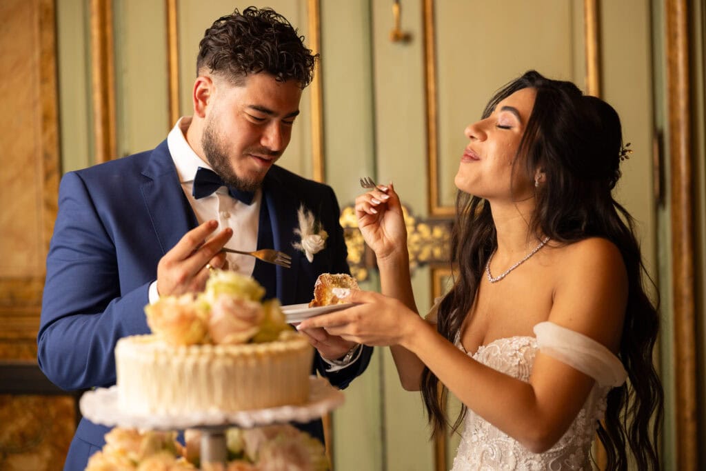 Emotional cake-cutting moment with bride and groom smiling at Villa Wenkenhof wedding in Switzerland.