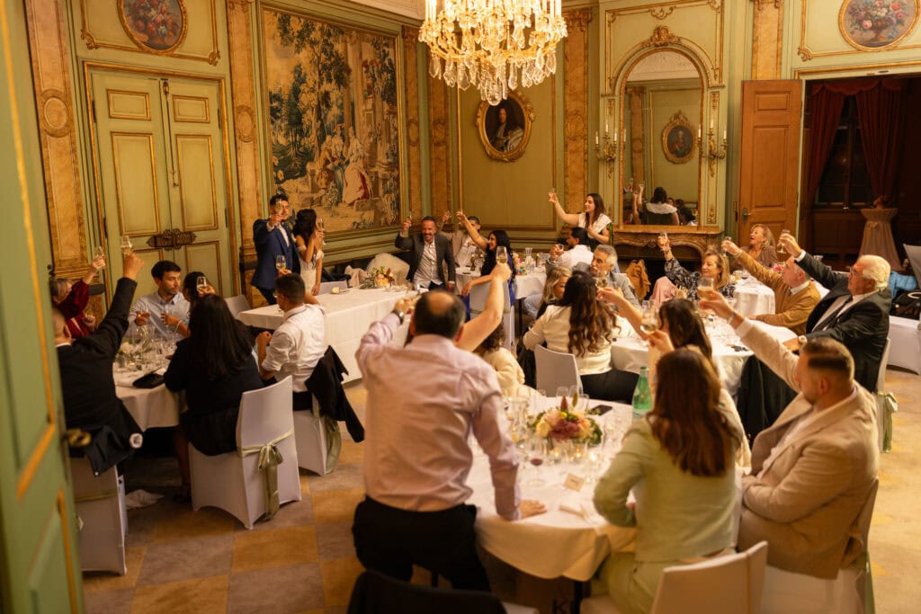 Toast with bride, groom and guests at Villa Wenkenhof wedding in Switzerland.