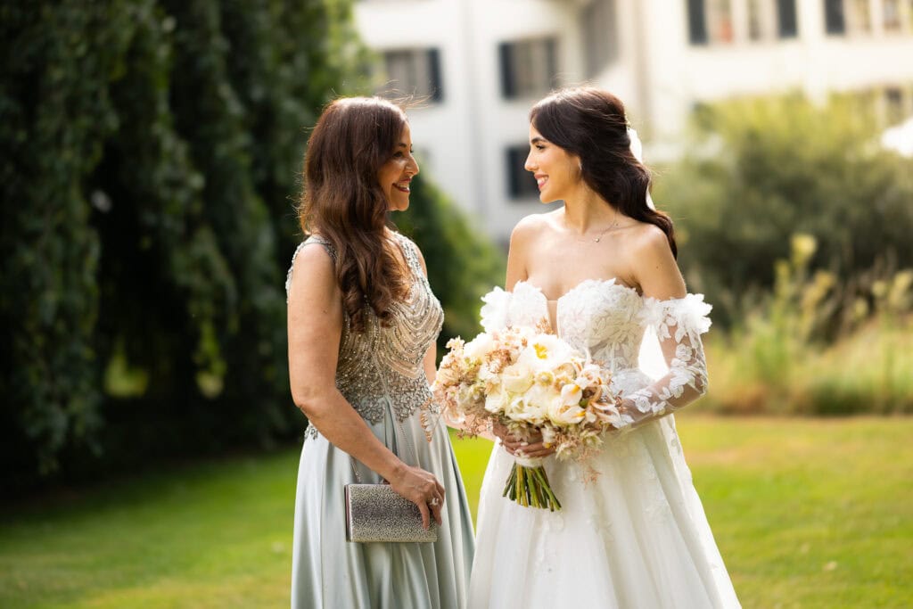 Wedding ceremony in the garden. Schloss Hünigen. Emotional and colorful wedding ceremony. Emotional hugs with family and friends after the wedding ceremony. Bride with her mum
