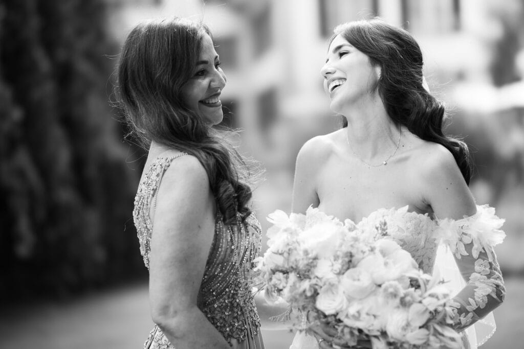 Wedding ceremony in the garden. Schloss Hünigen. Emotional and colorful wedding ceremony. Emotional hugs with family and friends after the wedding ceremony