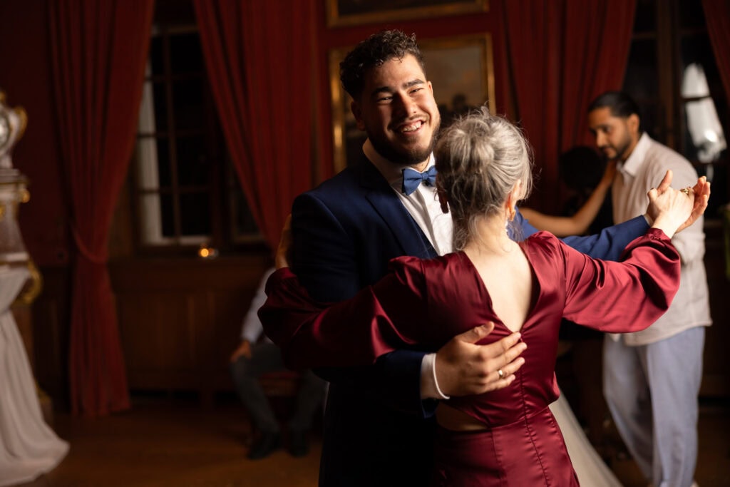 Groom dancing with her mum and celebrating during the wedding party at Villa Wenkenhof in Basel.