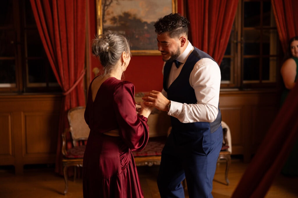 Groom dancing with her mum and celebrating during the wedding party at Villa Wenkenhof in Basel.
