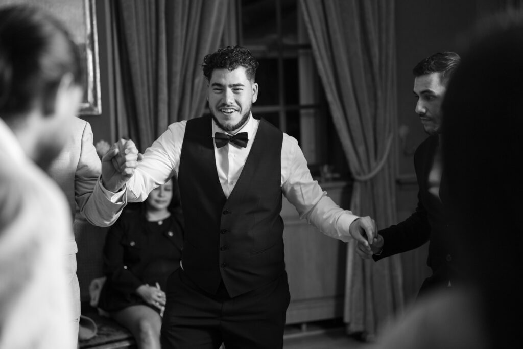 Groom dancing and celebrating during the wedding party at Villa Wenkenhof in Basel.
