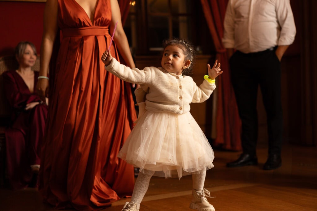 Kid playing and celebrating during the wedding party at Villa Wenkenhof in Basel.