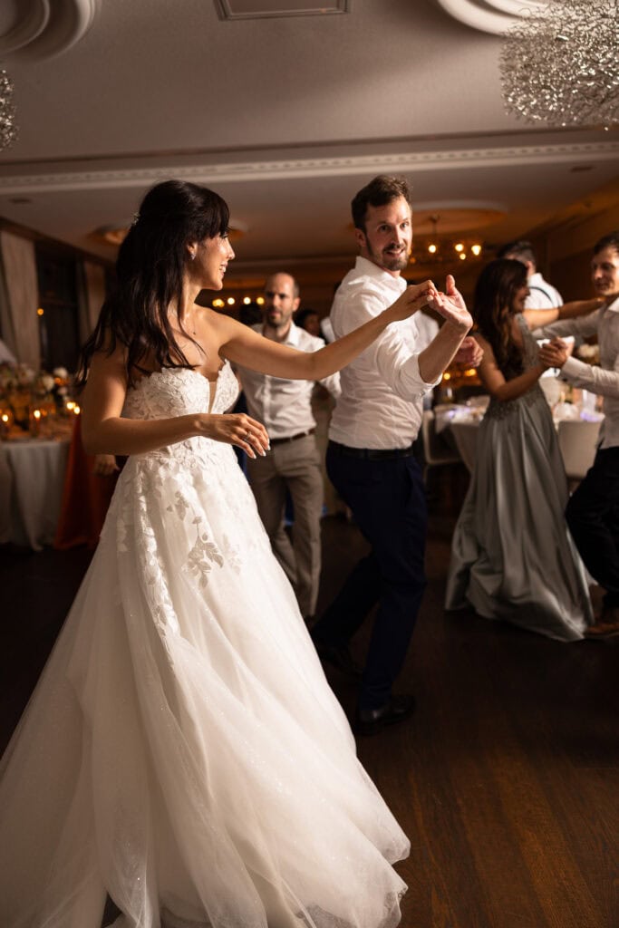 Bride and groom dancing and celebrating during the wedding party at Schloss Hünigen in Bern