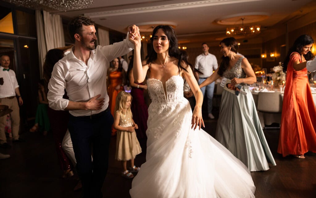 Bride and groom dancing and celebrating during the wedding party at Schloss Hünigen in Bern