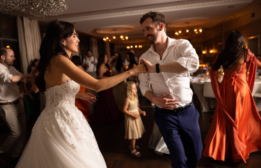 Bride and groom dancing and celebrating during the wedding party at Schloss Hünigen in Bern