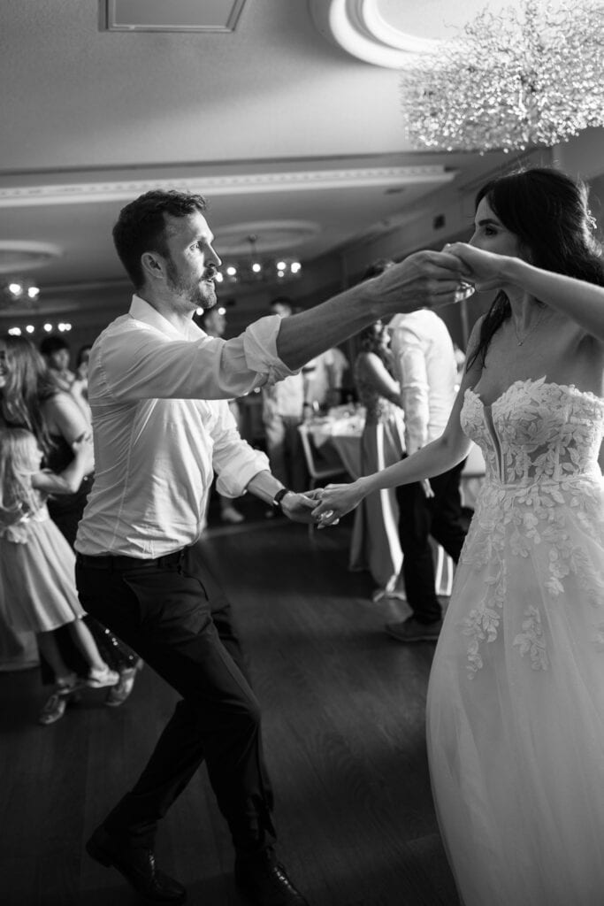 Bride and groom dancing and celebrating during the wedding party at Schloss Hünigen in Bern
