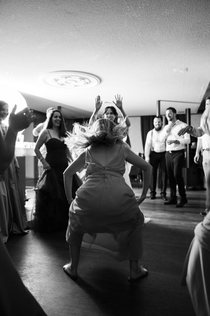 Guests dancing and celebrating during the wedding party at Schloss Hünigen in Bern
