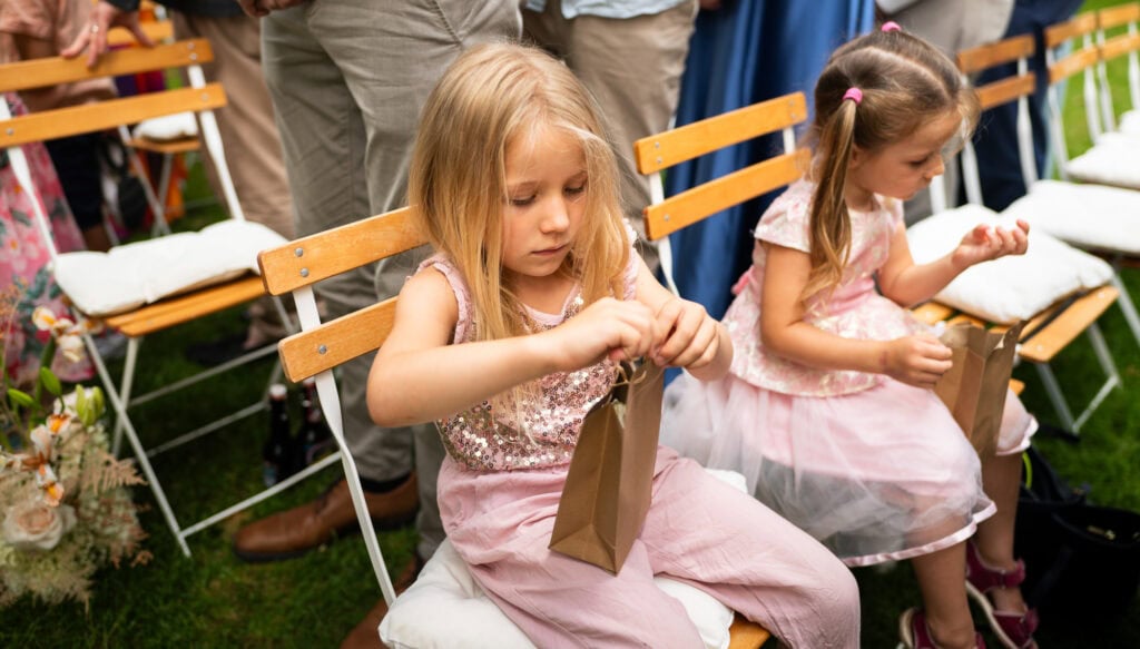 Wedding ceremony in the garden. Schloss Hünigen. Emotional and colorful wedding ceremony. Entry bride and her mum. Kids