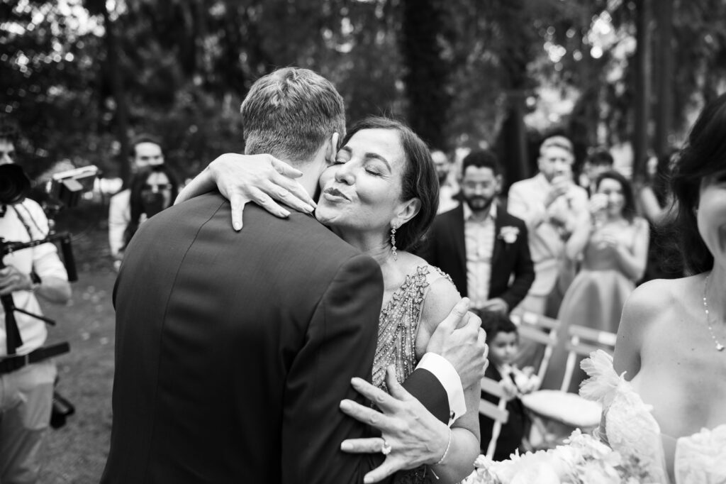 Wedding ceremony in the garden. Schloss Hünigen. Emotional and colorful wedding ceremony. Entry bride and her mum