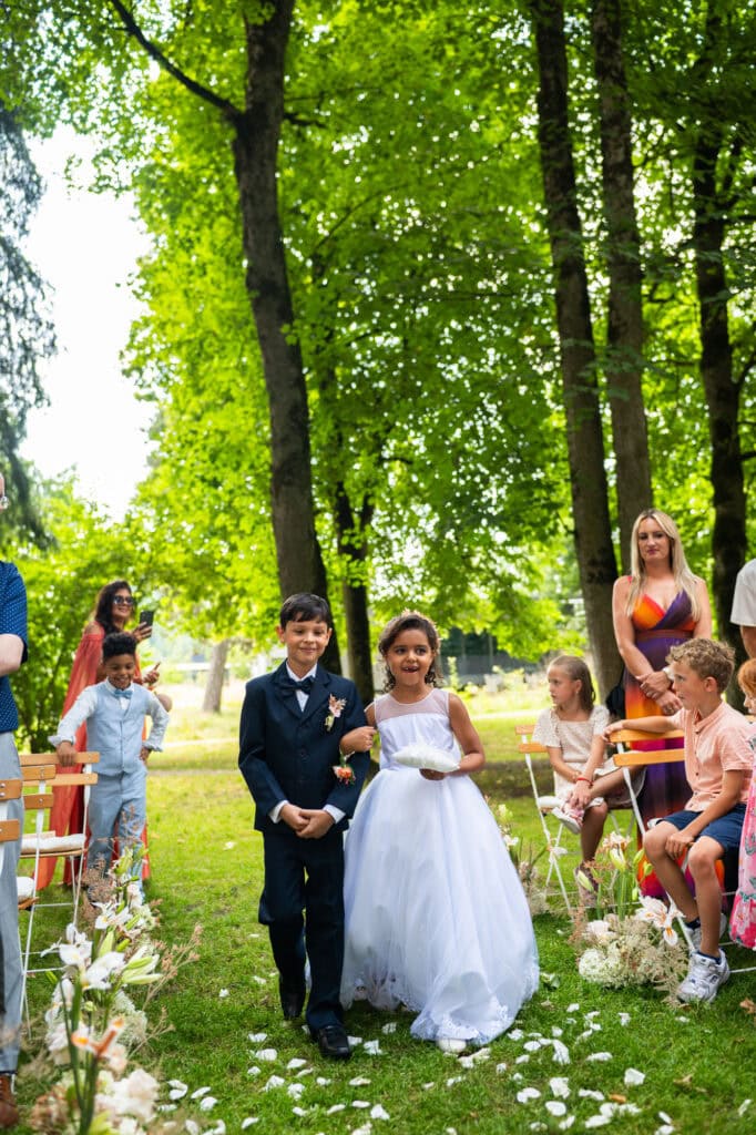 Wedding ceremony in the garden. Schloss Hünigen. Emotional and colorful wedding ceremony. Kids bringing rings