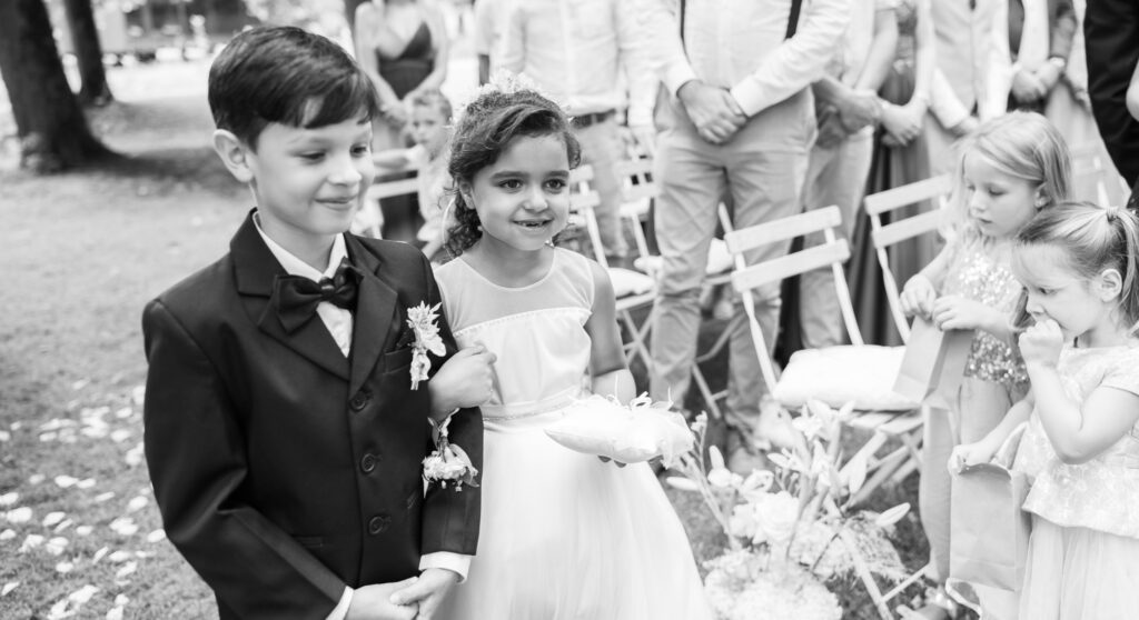 Wedding ceremony in the garden. Schloss Hünigen. Emotional and colorful wedding ceremony. Kids bringing rings