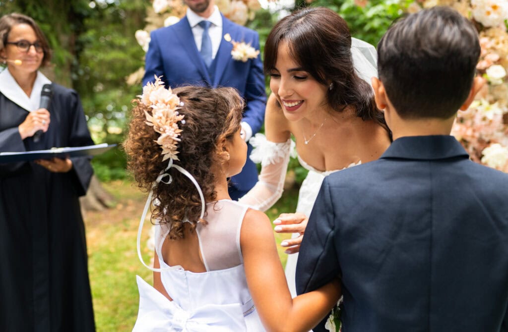 Wedding ceremony in the garden. Schloss Hünigen. Emotional and colorful wedding ceremony. Kids bringing rings