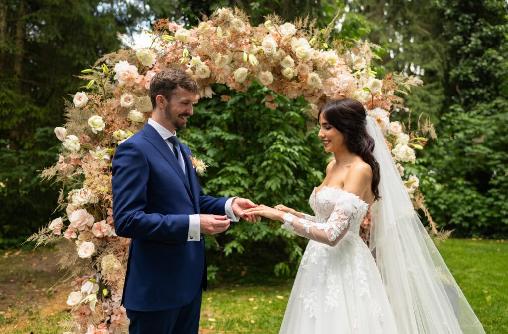 Wedding ceremony in the garden. Schloss Hünigen. Emotional and colorful wedding ceremony. Wedding rings moment