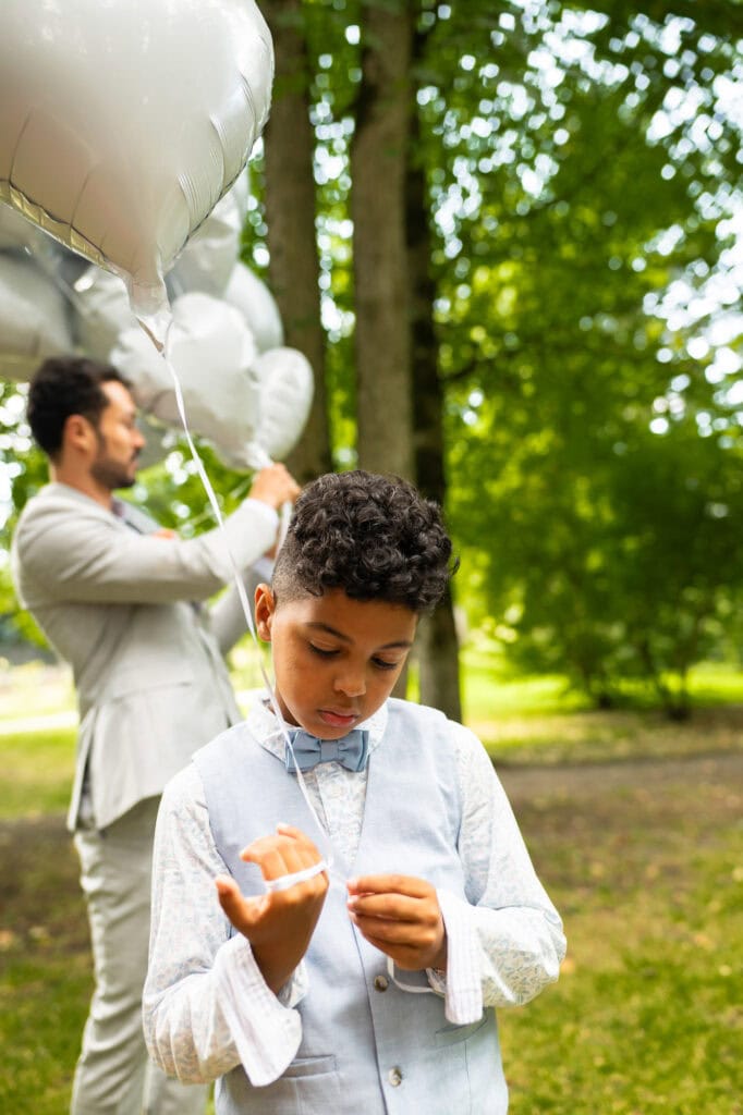 Wedding ceremony in the garden. Schloss Hünigen. Emotional and colorful wedding ceremony. Kid playing