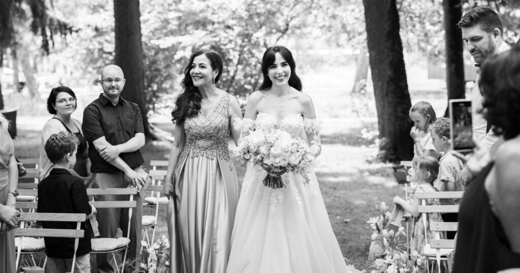 Wedding ceremony in the garden. Schloss Hünigen. Emotional and colorful wedding ceremony. Entry bride and her mum