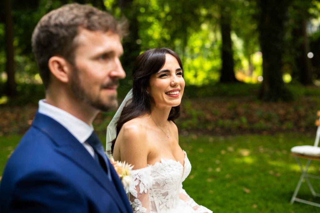Wedding ceremony in the garden. Schloss Hünigen. Emotional and colorful wedding ceremony.