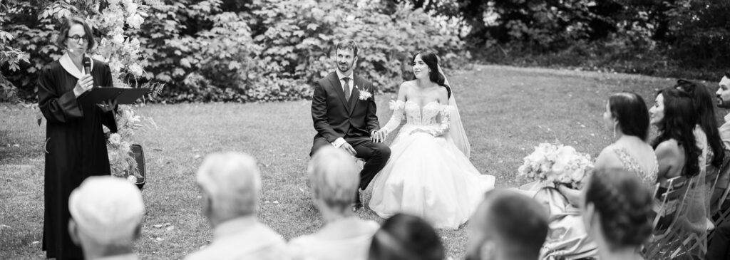 Wedding ceremony in the garden. Schloss Hünigen. Emotional and colorful wedding ceremony. Bride and groom