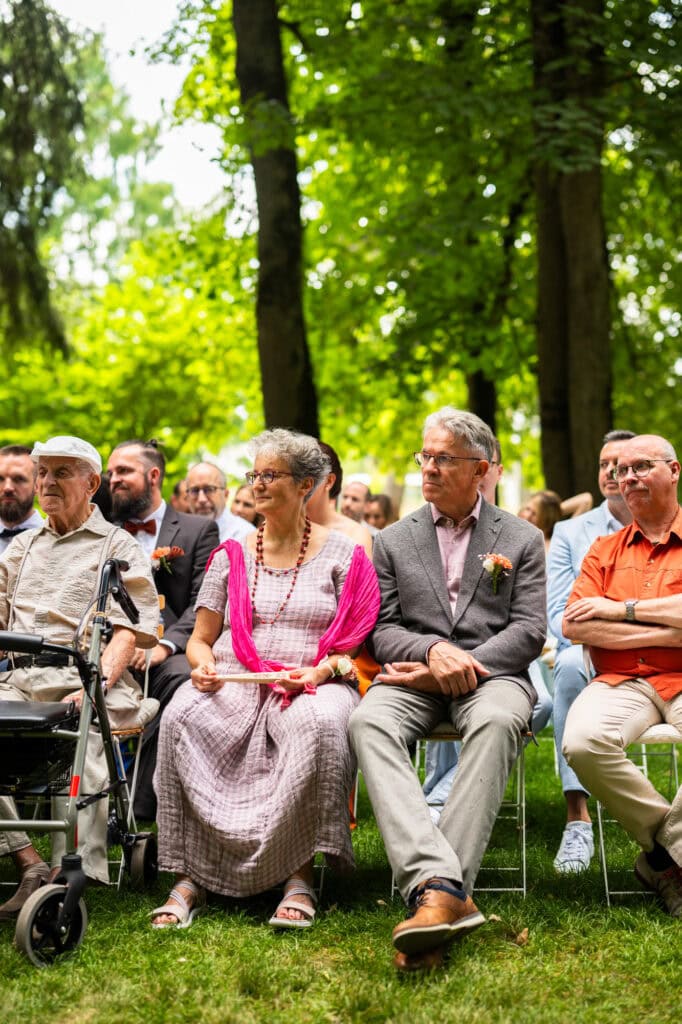 Wedding ceremony in the garden. Schloss Hünigen. Emotional and colorful wedding ceremony. Wedding guests