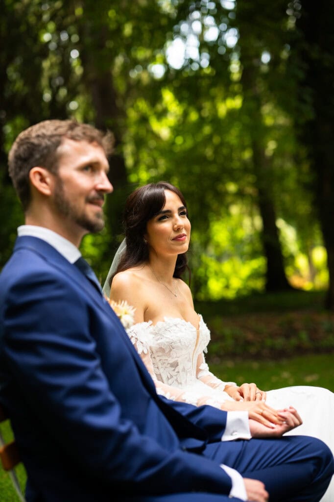 Wedding ceremony in the garden. Schloss Hünigen. Emotional and colorful wedding ceremony. Bride and groom