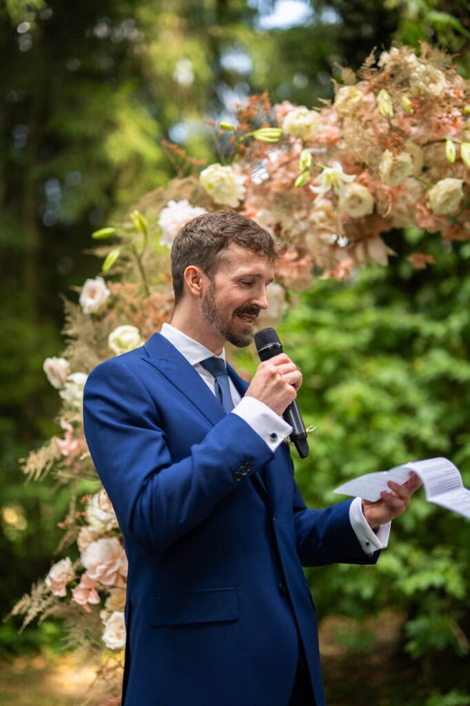 Wedding ceremony in the garden. Schloss Hünigen. Emotional and colorful wedding ceremony. Groom vows