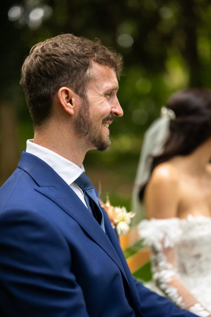Wedding ceremony in the garden. Schloss Hünigen. Emotional and colorful wedding ceremony. Groom