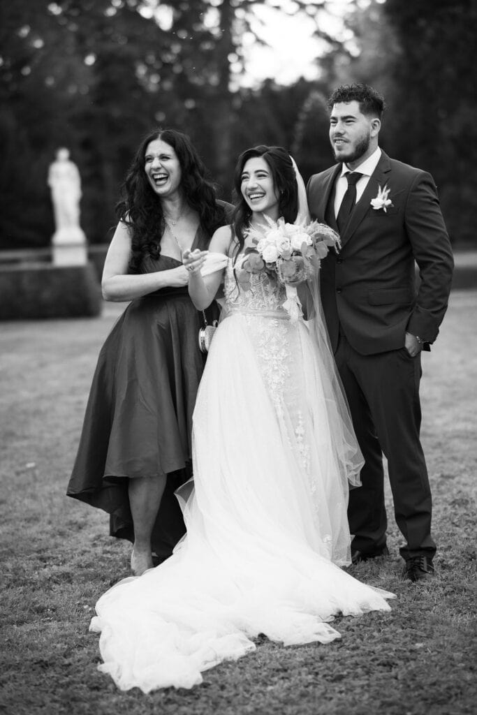 Group photo of bride, groom and friends in the gardens of Villa Wenkenhof, Switzerland.