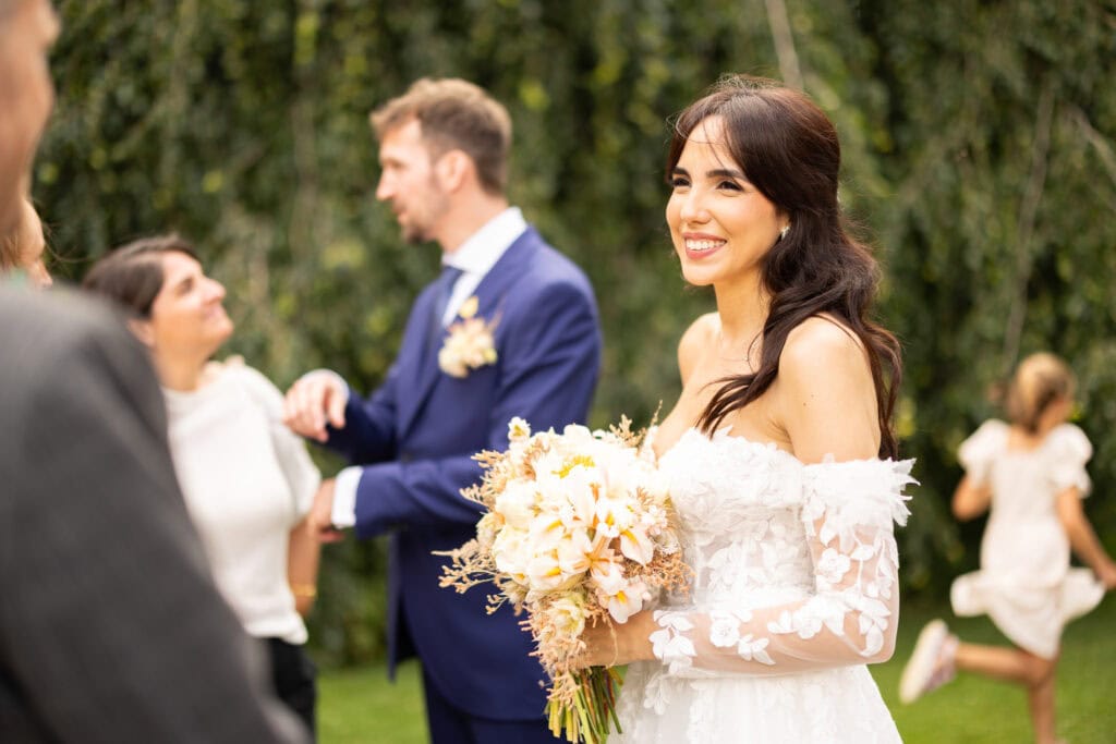 Wedding ceremony in the garden. Schloss Hünigen. Emotional and colorful wedding ceremony. Emotional hugs with family and friends after the wedding ceremony