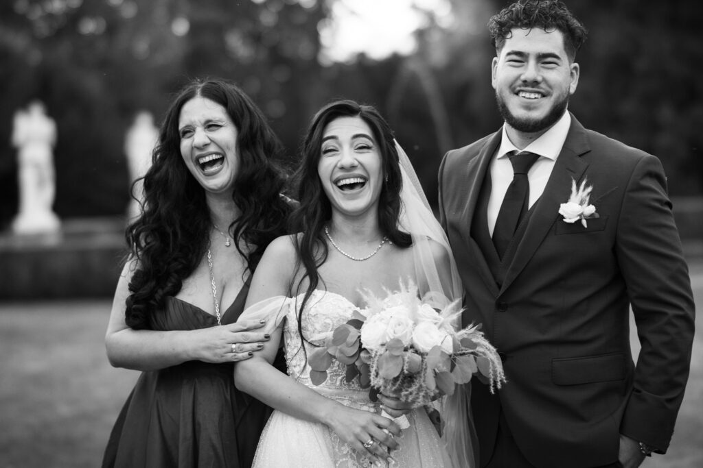 Group photo of bride, groom and friends in the gardens of Villa Wenkenhof, Switzerland.