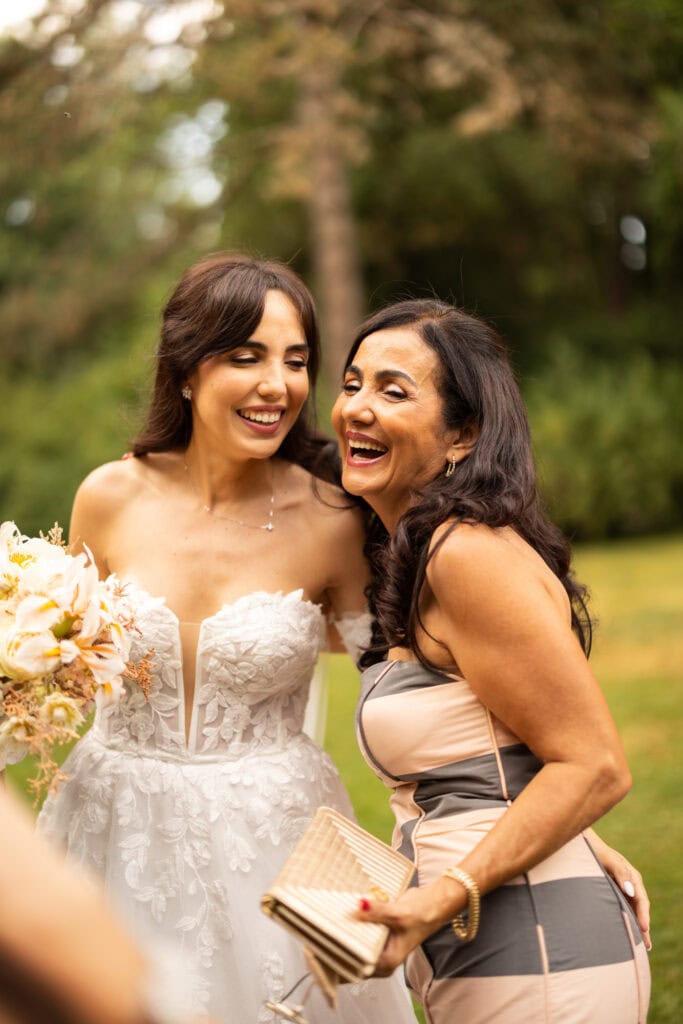 Wedding ceremony in the garden. Schloss Hünigen. Emotional and colorful wedding ceremony. Emotional hugs with family and friends after the wedding ceremony