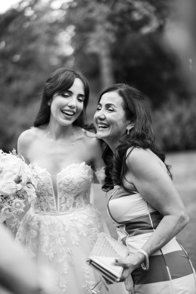 Wedding ceremony in the garden. Schloss Hünigen. Emotional and colorful wedding ceremony. Emotional hugs with family and friends after the wedding ceremony