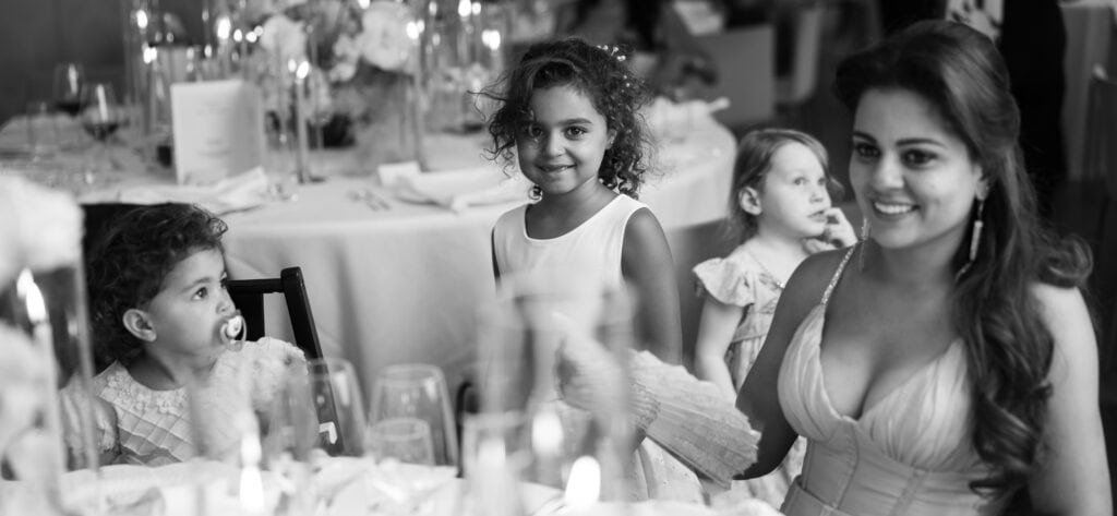 Children sitting at the dinner table during the wedding reception at Schloss Hünigen in Bern