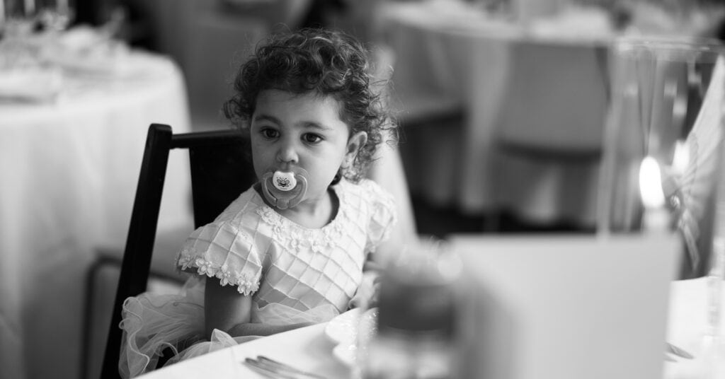 Children sitting at the dinner table during the wedding reception at Schloss Hünigen in Bern