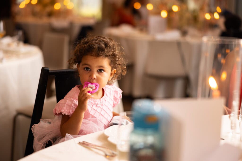 Children sitting at the dinner table during the wedding reception at Schloss Hünigen in Bern