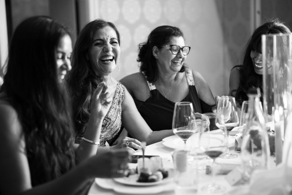 Guests sitting at the dinner table during the wedding reception at Schloss Hünigen in Bern