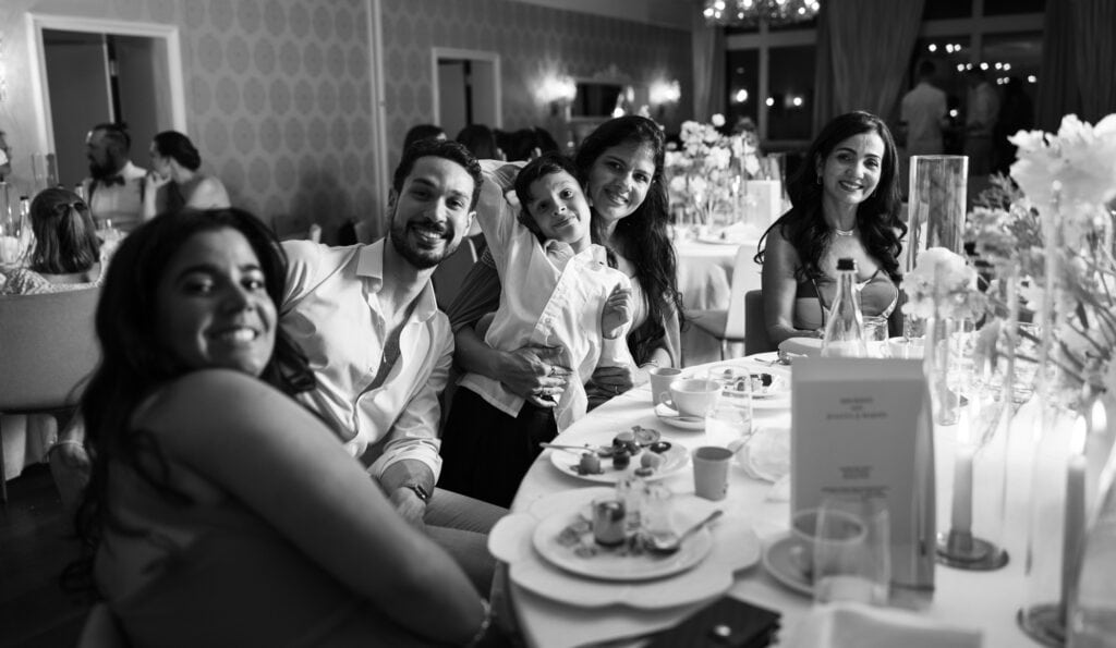 Guests sitting at the dinner table during the wedding reception at Schloss Hünigen in Bern