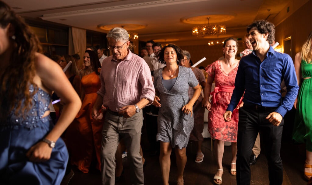 Guests dancing and celebrating during the wedding party at Schloss Hünigen in Bern